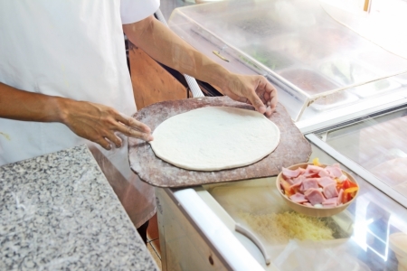 chef making pizza at kitchen の写真素材