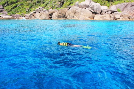 Young man snorkeling in clean water over coral reef, in Similan Island Phangnga South of Thailandのeditorial素材