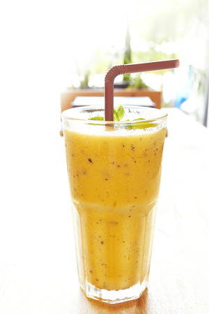 Mango with Passion fruit smoothie on wood backgroundの写真素材