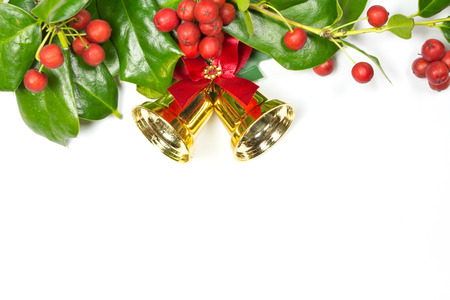Holly Christmas decoration, and golden bell on whiteの写真素材