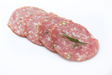 Smoked salami sausage. Sliced smoked sausage salami isolated の写真素材