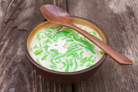 Thai dessert, rice noodles made of rice eaten with coconut milk on old wood tableの写真素材