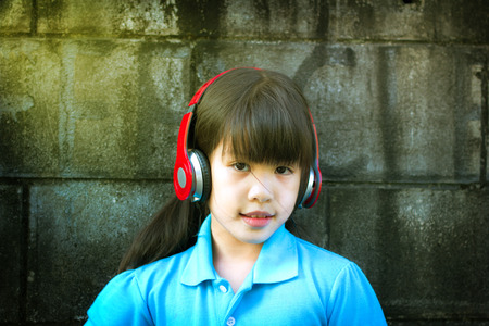 Cute Asian girl with headphonesの写真素材