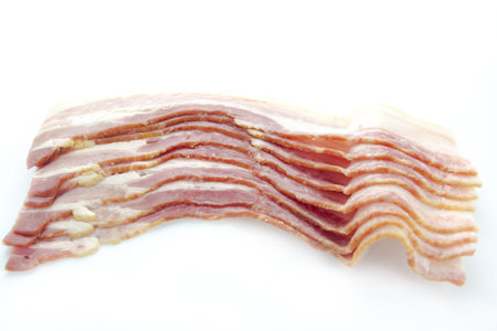 Raw dry-cured bacon on white background