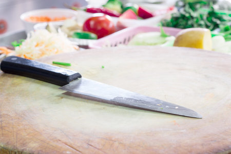 Knife in the kitchen with vegetable background