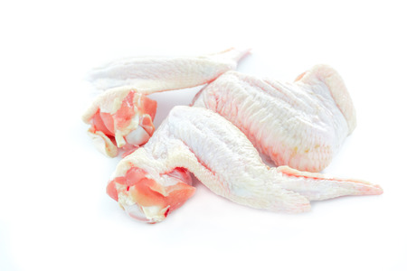 Close up raw chicken wings on a white backgroundの写真素材
