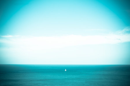 Blue sky and blue sea with loney ship, vintage toneの写真素材