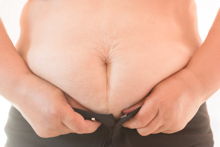 Close up Woman with belly fat getting dressed on white background
