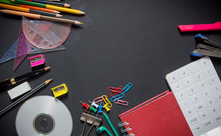 School supplies on blackboard background, View top