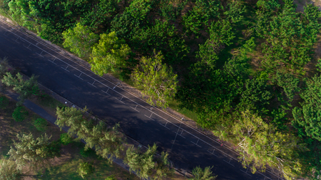 Aerial view over a road and forestの写真素材