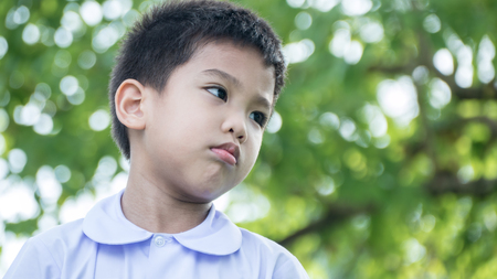 outdoor portrait of sadness a little asian boyの写真素材