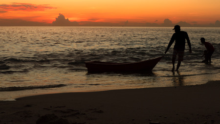 Silhouette shadow of fisherman at sunsetの写真素材