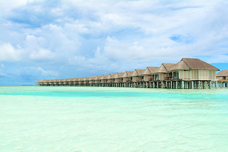 South Ari Atoll, Maldives - 12 July 2017: Beautiful tropical landscape with wooden villas of luxury resort above the crystal turquoise water of the Indian Ocean, Maldives island, 12 July 2017のeditorial素材