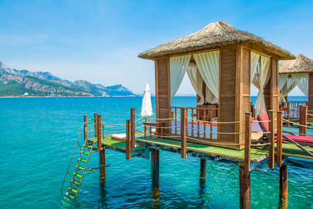 Antalya, Turkey - 12 May 2018: Wooden beach pavilions on the shore of a sandy beach - the Mediterranean coast, Beldibi, Antalya, Turkeyのeditorial素材