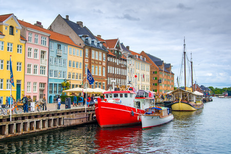 Copenhagen, Denmark - 29 August 2018: Colorful houses and boats on the embankment of the canal in the Nyhavnのeditorial素材