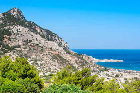 Landscape of beautiful bay in Rhodes island with mountain and rocky beachの写真素材