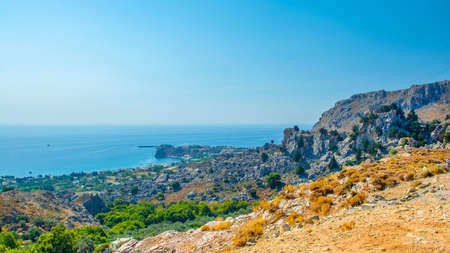 Landscape of beautiful bay in Rhodes island with mountain and rocky beachの写真素材