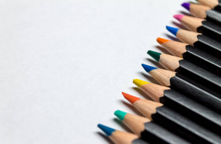 Colored pencils across white paperの写真素材