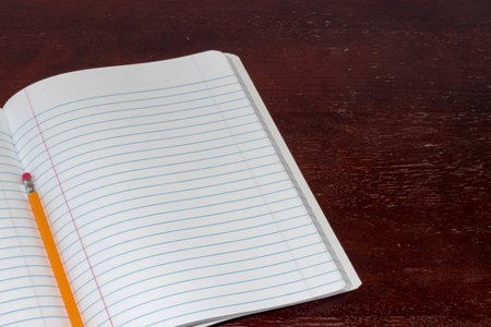 Open notepad and pencil on a tableの写真素材