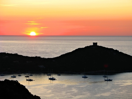 Corsican susnet with a typical genoese towerの写真素材