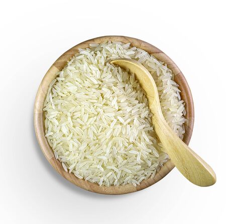 Parboiled Rice and wooden spoon in a wooden cup isolated on white background. with clipping paths.の写真素材