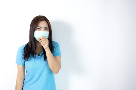 Asian women wear masks to prevent disease covid 19, long haired-black women. Wearing a blue collar shirt. Woman coughing on white background.の写真素材
