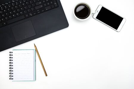 Office desktop with accessories and white coffee cup on white table. Top view. Business background. の写真素材