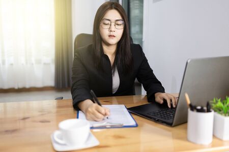 Bussiness woman working discussing the charts. Work form home concept. Asian woman.の写真素材