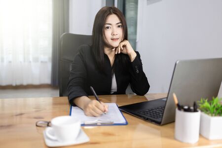 Work from home concept. Asian pretty smiling bussiness woman. の写真素材