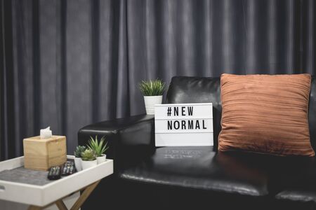 Lightbox sign with text hashtag #NEW NORMAL in home decor. New normal concept. Social distancing.の写真素材