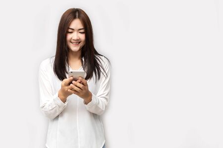 Asian women are reading good news on smart phones. News people concept. isolated on white background.の写真素材