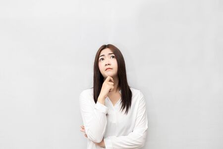 Long-haired Asian women are standing thinking isolated on white background.の写真素材