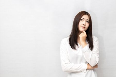 Long-haired Asian women are standing thinking isolated on white background.の写真素材