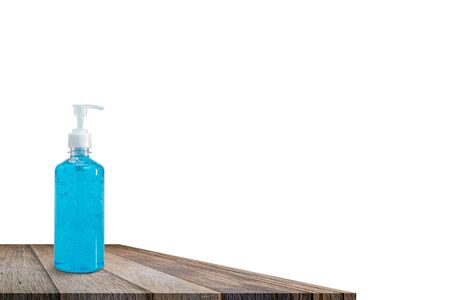 Hand sanitizer bottle on wooden table top isolated on white background. Please wash your hands concept. with clipping paths.の写真素材
