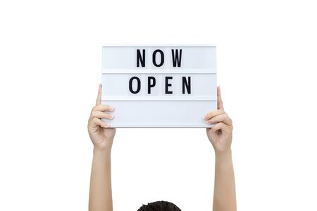 Womanâs hands holding sign now open support local business. sign for the reopening of the place after the quarantine due to covid-19.の写真素材