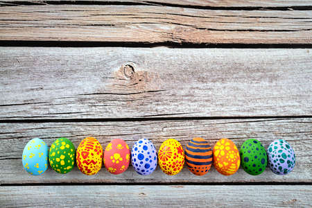 Colorful easter eggs on wooden rustic table.の写真素材