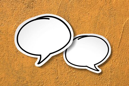 White paper cut speech bubble on yellow vintage background.の写真素材