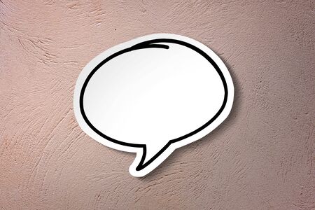 White paper cut speech bubble on pink vintage wall background.の写真素材