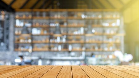 Wood table top on blur coffee shop background. For montage product display or design key visual layout.の写真素材