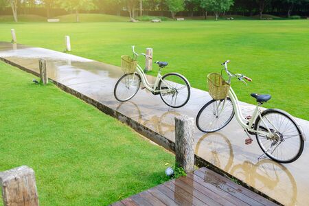 Two vintage bicycles parked on the walkway in the garden. Vacation concept.の写真素材