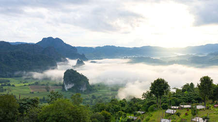 Majestic view on beautiful fog mountains in mist landscape. Dramatic unusual scene. Travel background.の写真素材