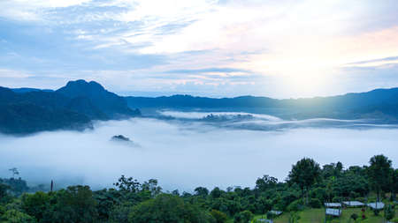 Mountains in fog at beautiful sunset in autumn. Landscape view.の写真素材