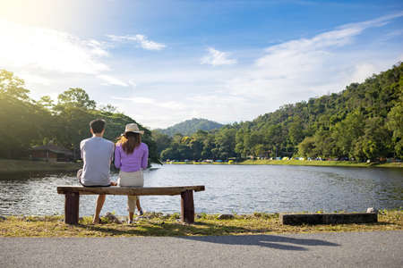 Travelers couple look at the mountain lake.の写真素材