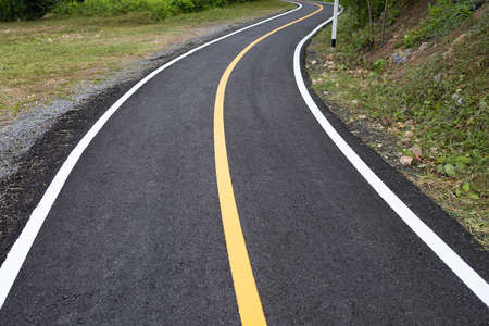 Jogging black track at the park with white and yellow line.の写真素材