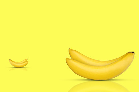 Fresh and sweet bananas on yellow background.の写真素材