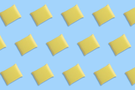 Seamless pattern of yellow sponges for washing dishes on blue background.