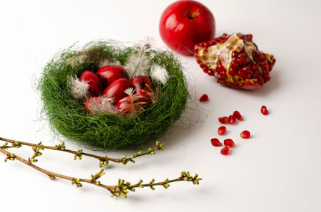 Quail red Easter eggs in a green nest on a white background. Holidays concept