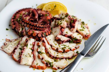 Seafood appetizer. Octopus Carpaccio on white plate. Mediterranean delicacy. Selective focusの写真素材