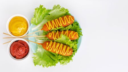 American fast food. Corn dogs on white background. Copy space, top viewの写真素材