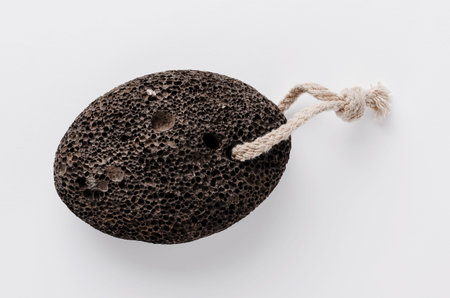 Pumice stone on white background. Home heel care.